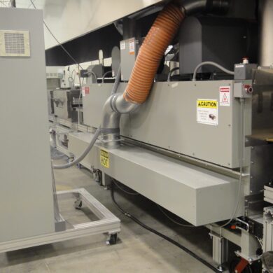 Custom drying oven with solid belt conveyor.